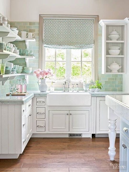 Open concept kitchen with farmhouse sink and green subway tile