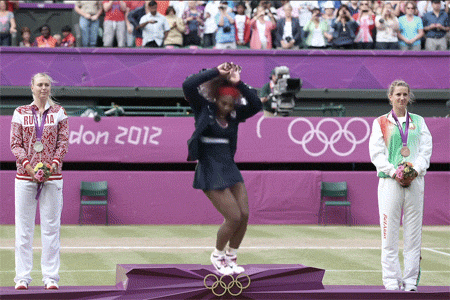 Black woman tennis player with natural African or relaxed hair playing dancing on spot. 