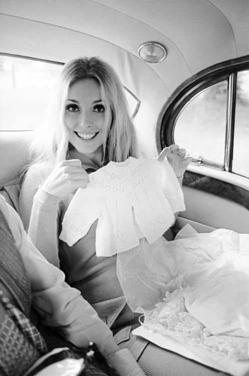 Pregnant Sharon Tate, 6 August 1969, holding up a baby jumper in the back of a London cab. This picture was taken three days before she was murdered.