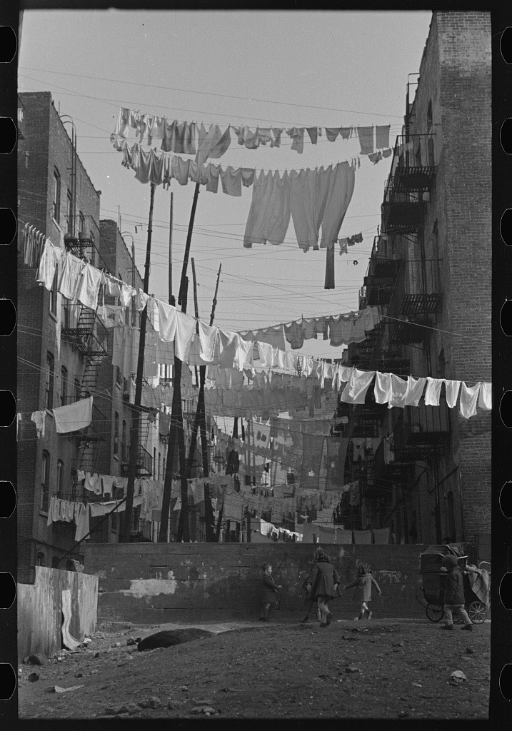 An avenue of clothes washings between 138th and 139th Street apartments, just east of St. Anne’s Avenue, Bronx, New York. 1936.