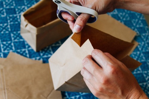 Prepping paper bags as part of a snack bag diy.