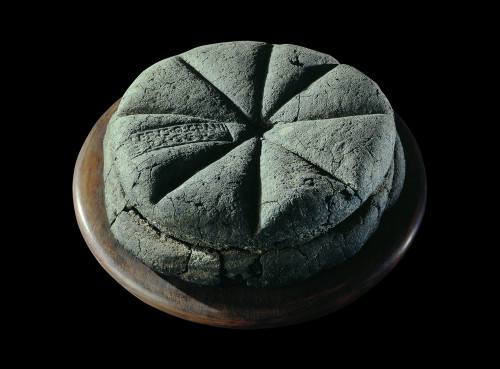 museum-of-artifacts:
“  A carbonised loaf of bread with the stamp ‘Property of Celer, Slave of Q. Granius Verus’ from Herculaneum (near Pompeii), 79 AD
”