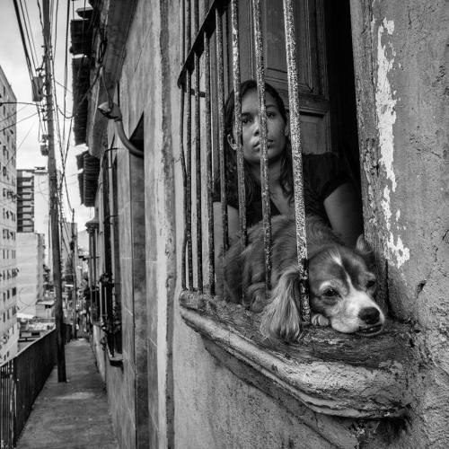 In Caracas, Venezuela, Bendiré peers from the window of an...