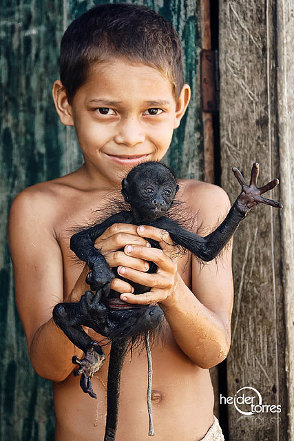 boy holding monkey