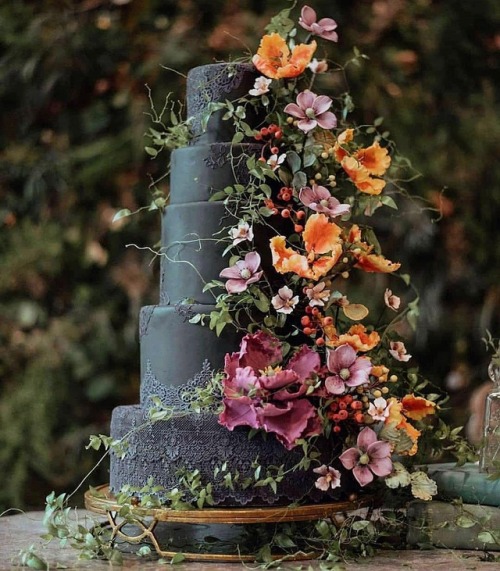 Love how the color of the flowers accentuate the black cake...