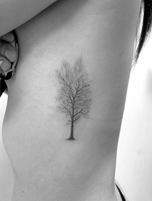 Fine line leafless tree tattoo on the side boob