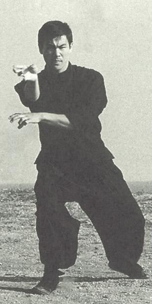 gutsanduppercuts:A young Bruce Lee practicing on the beach...