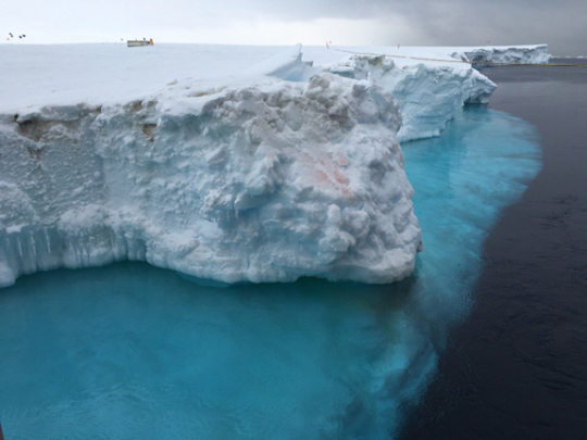 Antarctic huge ice mountain sitting on the sea