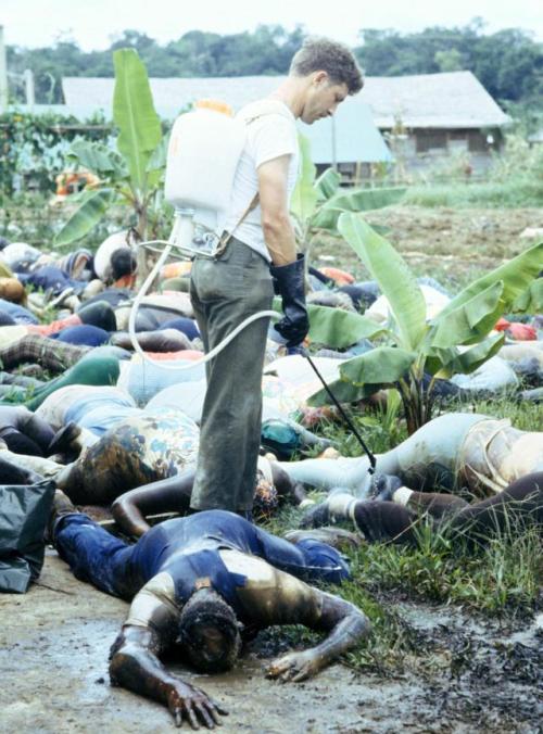 historicaltimes:A US Army officer sprays disinfectant over the...