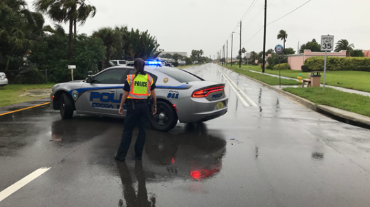 Police car standing on the road to help the people who affected by storm