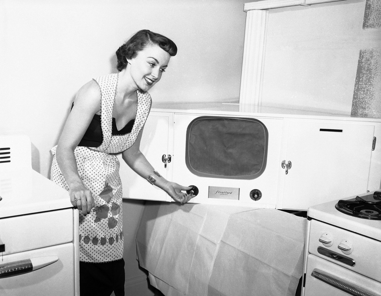 Plymouth, Vermont: an unidentified woman shows a television set inside the house where Calvin Coolidge was born, August 19, 1953