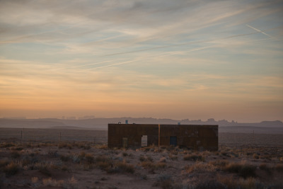 archatlas:<br /><br />Mexican Water Cabins DesignBuildBLUFF<br /><br /><br />The Mexican Water Chapter of the Navajo Nation partnered with Design Build BLUFF (and University of Colorado Students)  to construct two rentable cabins; with the idea that tourism dollars otherwise lost outside the boundaries of the reservation could rather stay and help encourage the local economy. Influenced by the landscape and distant views of the Blue Mountains and Monument Valley, the design led to the development of two “sibling” cubes. One rests on the landscape while the other emerges from it. <br /><br /><br />Images and text via DesignBuildBLUFF<br /><br /><br />