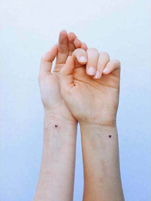 By Zayahastra, done in London. http://ttoo.co/p/149977 small;matching;zayahastra;micro;family;matching tattoos for siblings;heart;tiny;sister;love;ifttt;little;matching sister;wrist;minimalist