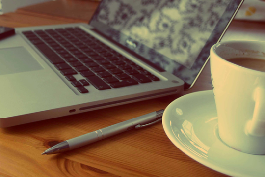 laptop with tea cup on the table