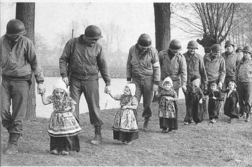 historicaltimes:Dutch girls escorting American soldiers to a...