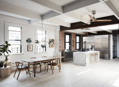 Kitchen and dining area uses contrasting colors and textures to create a sense of separate spaces in this loft apartment in TriBeCa. [1280 × 932]