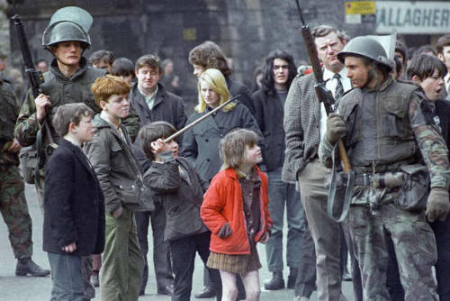 historicaltimes:Local children taunt a British soldier as he...