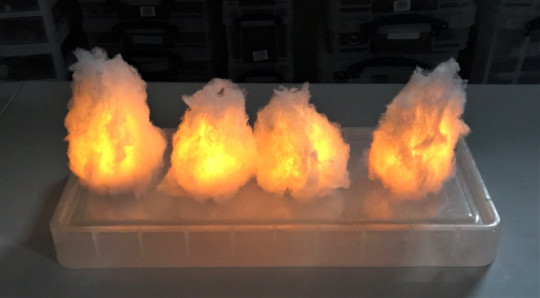 2 unpainted smoke markers lit up in dark