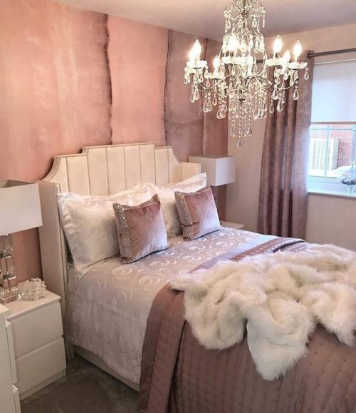 Fur pillows chandelier bedroom