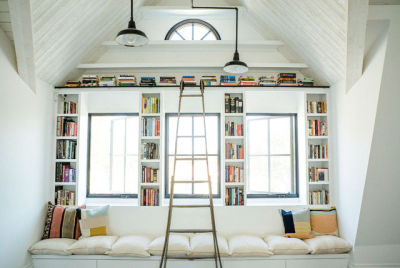 Bright reading area has book cases built around the windows in a home designed by Leanne Ford Interiors. [1600 × 1069]