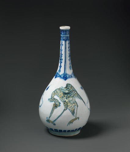 Bottle Depicting Storks in Blue and Yellow on a White...