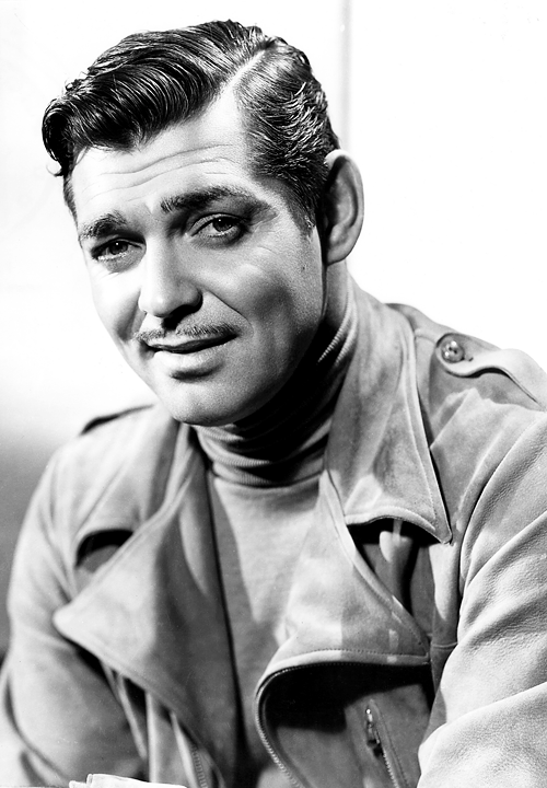 Clark Gable wearing an overcoat with a turtleneck sweater