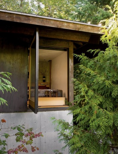 archatlas:<br /><br /><br /><br />Tye River Cabin Olson KundigSituated in a dense forest near the Tye River, this meditative retreat connects to the nature that surrounds it.The square base of the two-level structure is rendered in cast-in-place concrete, as is the large central fireplace that serves as the core and anchor for the cabin. Custom-designed, pivoting glass windows swing open to reveal the corners and sides of the space, blurring the line between inside and outside. Rusted mild steel siding wraps the exterior areas not given over to windows. Deep overhangs shelter the main living area from the regular rain showers. Concrete patios extend the living space outdoors and follow the contours of the land toward the water.Images and text via<br /><br /> Olson Kundig<br /><br />