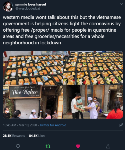 The image shows a tweet with the caption text, and four different pictures. The top two pictures show packaged meals stacked up on tables. The bottom two show a woman in scrubs and a surgical mask covering mouth and nose, handing out meals to various Vietnamese citizens, also wearing masks.