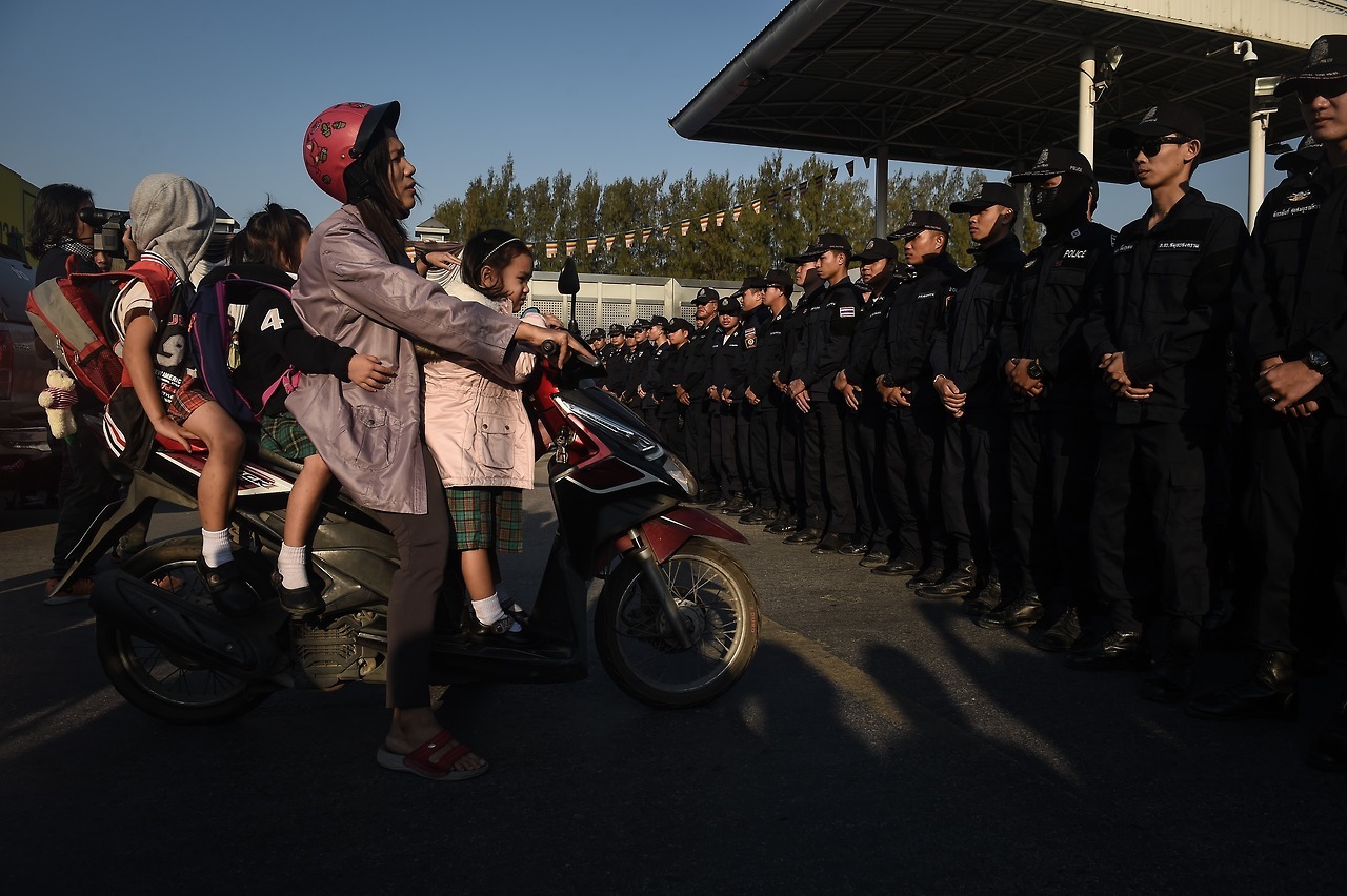 PBS NewsHour — Today’s photo of the day: A woman trying to take...