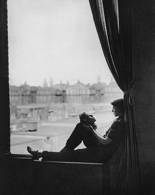 Sculptor Jessie Stonor looks at a mask of herself, London, 1938