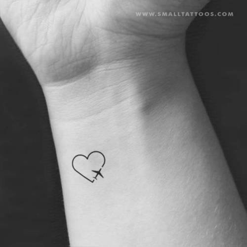 Minimalist airplane and heart tattoo on the inner