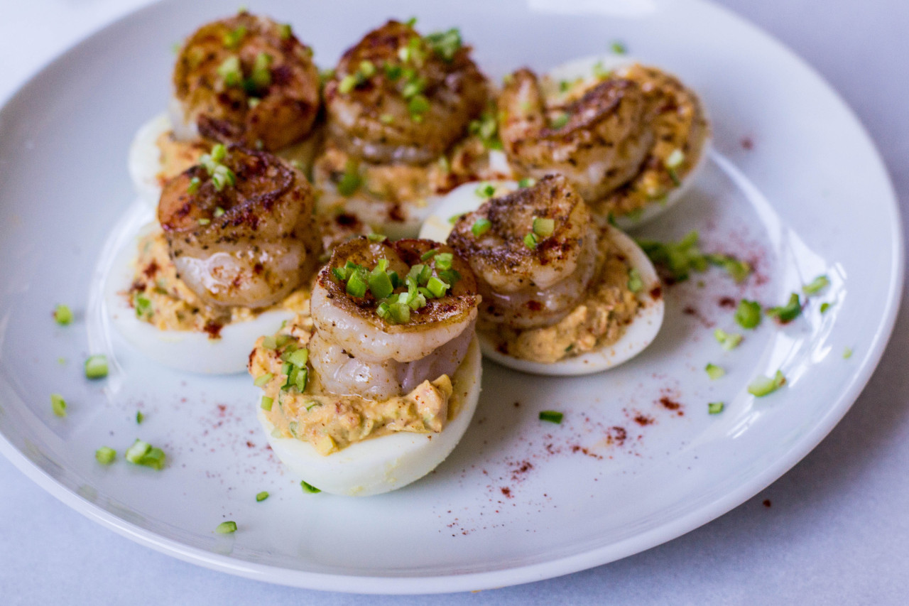 Image of Cajun-spiced shrimp over deviled eggs from the blog Seasoned to Taste