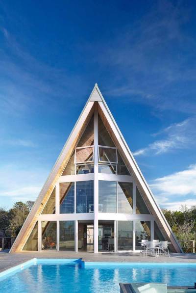 cjwho:<br /><br />A-Frame Residence, New York, USA by Bromley Caldari Architects | via<br />This striking looking A-Frame Residence is the result of an architecture conversion delivered by New York City-based studio Bromley Caldari Architects. The designers completely renovated the interiors of a 1960s beach home on Fire Island, turning it into a sleek hideout. With a spiral staircase splitting down the middle, four dark and cramped bedrooms, a leaky roof, and a cracked pile foundation, the original building required serious interventions.<br />By adding a new staircase, the layout was positively transformed and functionality took over he entire abode: “On the main level, a double-height living/dining room stretches the length of the window-clad north façade. The open kitchen and house utilities run along the south side. The master bedroom suite features full-height glass sliding doors that take advantage of the view. Although the doors stay mostly open, when guests are present and privacy is required, the sliding glass doors fog up at the flick of a switch.”<br />CJWHO:  facebook  |  instagram | twitter  |  pinterest  |  subscribe<br />