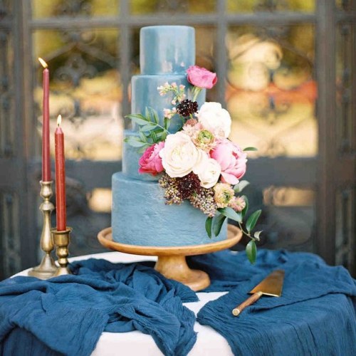 A very pretty 4 tier pastel blue cake with peonies and...