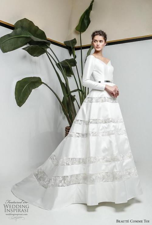 Who can resist this elegant long sleeve ball gown with a...