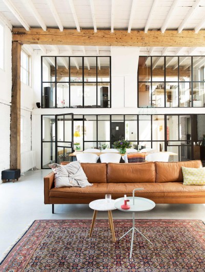 Living area preserves the original beams in a home which was originally a leather factory constructed in 1900 in the Dutch town of Gilze. [1356 × 1793]