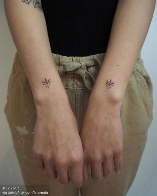 Hand poked ornament tattoo on the wrist.