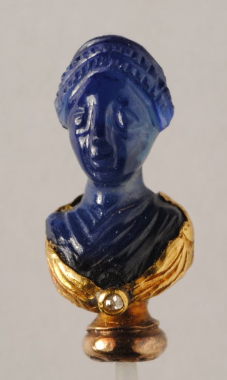 ancientpeoples:Dress-pin in the form of a carved sapphire and...