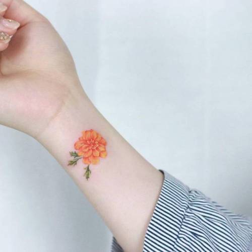 By Tattooist Ilwol, done in Seoul. http://ttoo.co/p/144841 marigold;flower;small;micro;tiny;ifttt;little;nature;wrist;tattooistilwol;illustrative