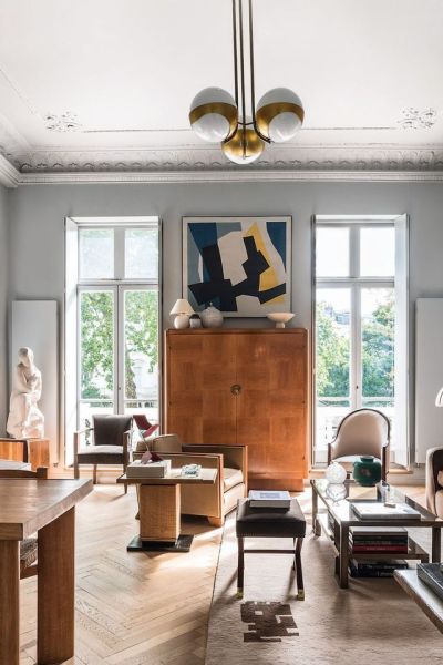 A pair of French windows leads from the sitting room to the terrace, with a painting by René Roche between them.