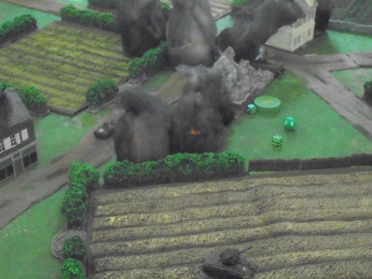 11 Artillery smoke and burning vehicles clog the crossroads