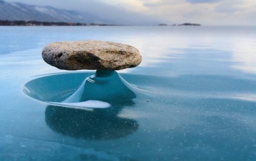 Rocks on the lake Baikal get heated from the sunlight every now and then and melt the ice beneath. After the sun is gone, the ice turns solid again thus creating a small stand for the rock above. It is called the Baikal Dzen.