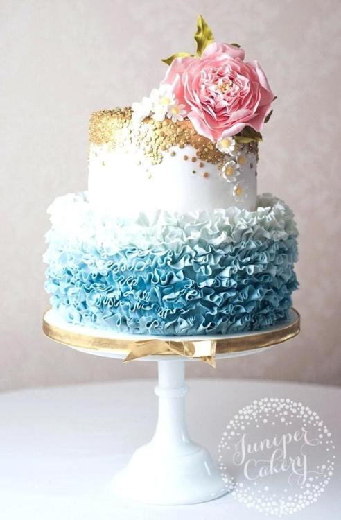 Pretty bluish ombre 2-tier cake topped with glittering gold by...