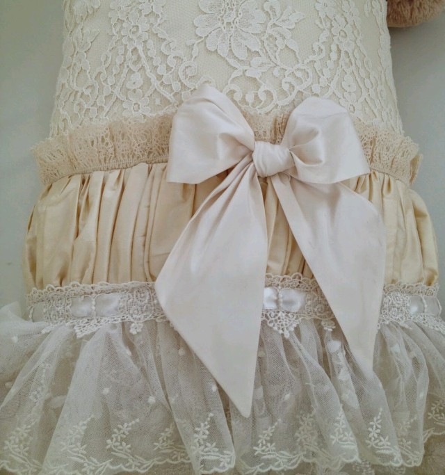 From Tuckaway Trail — Cream colored ruffles, laces, gathers and bow.