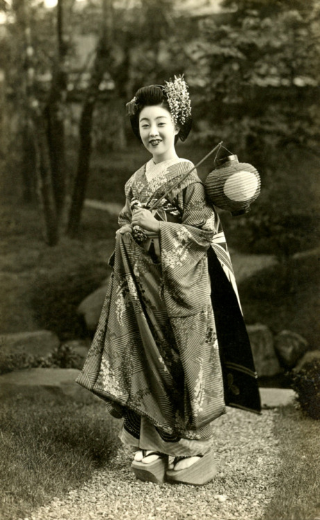 Maiko Teru in a Wisteria Kimono 1930s (by Blue Ruin1)
“ “In this month [May], maiko (apprentice geisha) wear light kimono and their kanzashi (ornamental hairpins) change from cherry blossoms of spring to wisteria flowers of early summer. This is the...