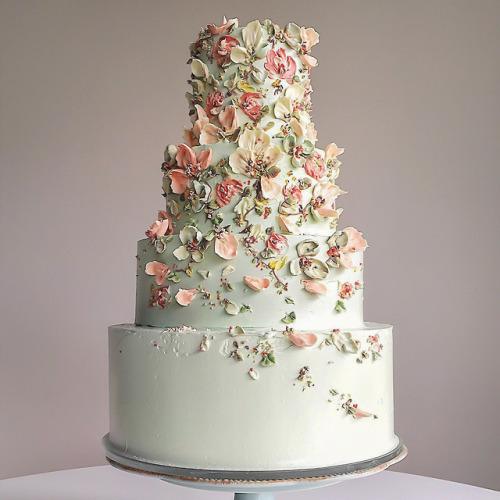 Beautiful pastel green wedding cake decorated with floral...