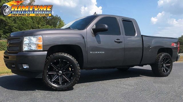 Chevy Silverado sitting on 20” XF Off Road XF-220 Black and Milled Wheels wrapped in 20” 33-12.5 Rockstar Mud Tires via RimTyme of Lithia Springs, GA (404) 815-2088