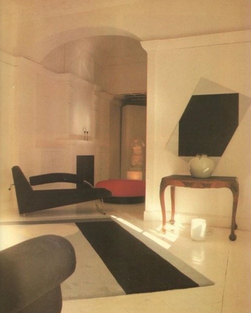 cream walls and floor, antique side table, black and red PoMo...