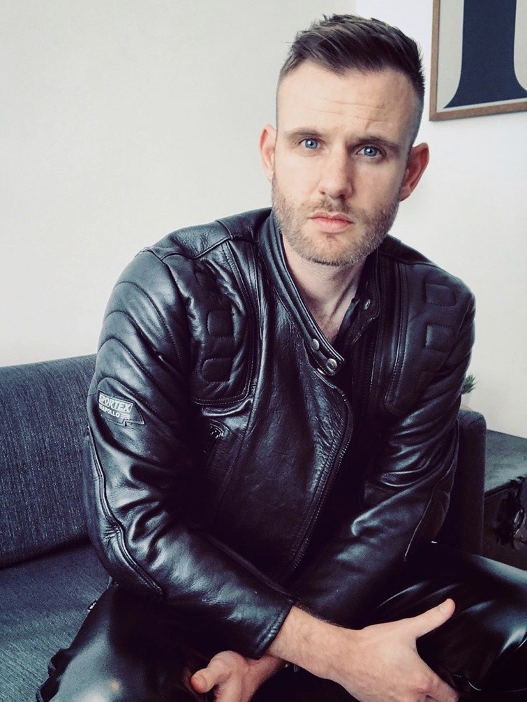 Punkerskinhead — attractive hunk with shaved head, in leather and...