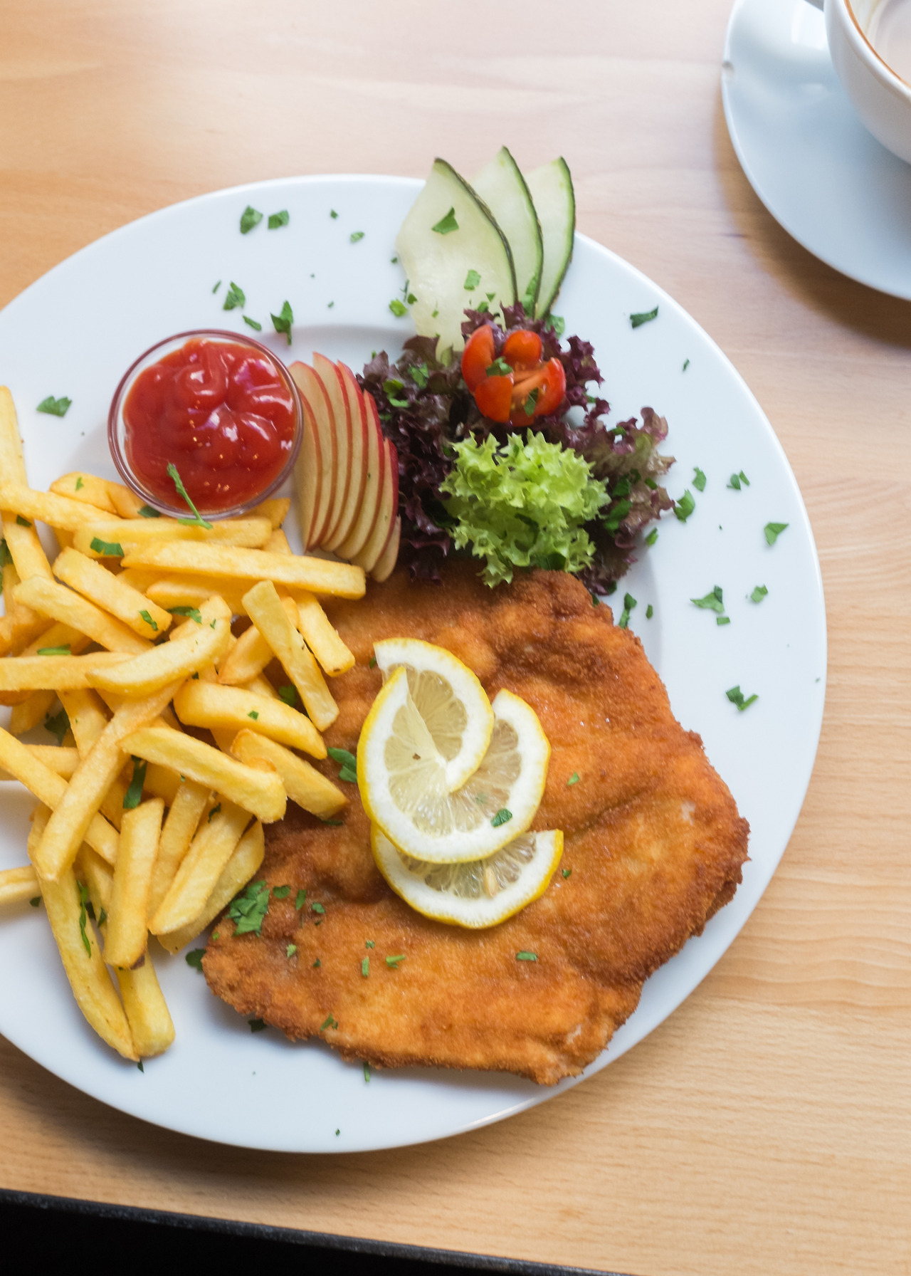 Cecile Vadas — Chicken schnitzel with fries and a fresh salad at...